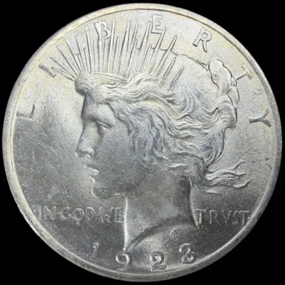 Sale Photo Thumbnail #34: Obverse side of a 1923 Peace silver dollar coin featuring the profile of Lady Liberty.