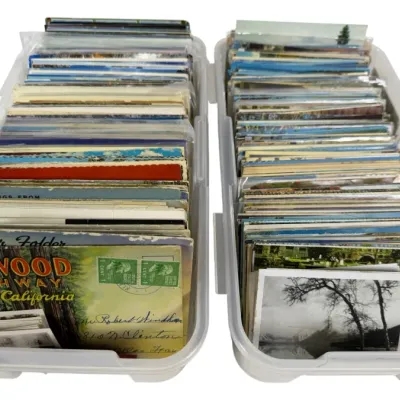 Sale Photo Thumbnail #4: Two plastic storage bins filled with vintage postcards and souvenir folders, including a Redwood Highway California souvenir folder.