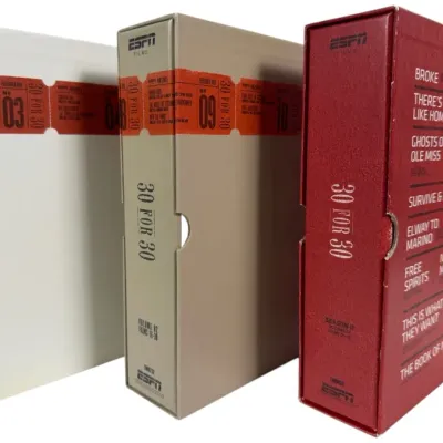 Sale Photo Thumbnail #157: Trio of ESPN Films "30 for 30" documentary DVD collector's box sets in white, tan, and red outer slipcases.