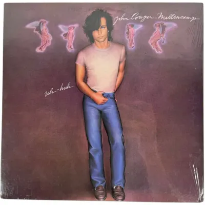 Sale Photo Thumbnail #137: John Cougar Mellencamp "Uh-Huh" 33 RPM vinyl record LP album, released in 1983. The album cover retains its original shrink wrap and shows light wear along the edges.