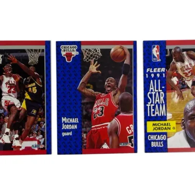 Sale Photo Thumbnail #10: Trio of 1991 Fleer Michael Jordan basketball trading cards, including League Leaders, base card, and All-Star Team inserts in good condition.