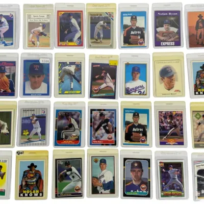 Sale Photo Thumbnail #15: Collection of 28 vintage Nolan Ryan baseball trading cards from various manufacturers including Topps, Donruss, Fleer, and Score, all housed in protective plastic sleeves.