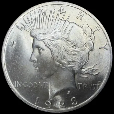 Sale Photo Thumbnail #29: Obverse side of a 1923 Peace silver dollar featuring Lady Liberty in profile.