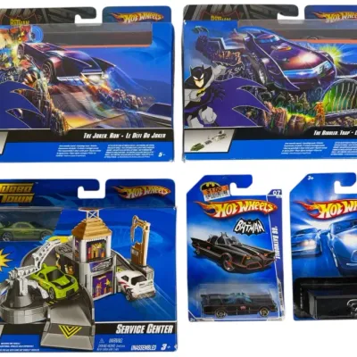 Sale Photo Thumbnail #175: Collection of Hot Wheels toys in original packaging, including Batman track sets, a Turbo Town Service Center, and carded die-cast vehicles from the 2000s.