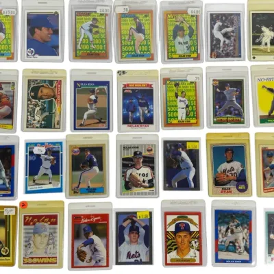 Sale Photo Thumbnail #14: Collection of 28 vintage Nolan Ryan baseball trading cards from various manufacturers, individually housed in protective sleeves and top loaders.