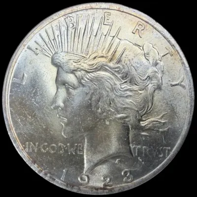 Sale Photo Thumbnail #39: Obverse side of a 1923 Peace silver dollar coin featuring Lady Liberty.