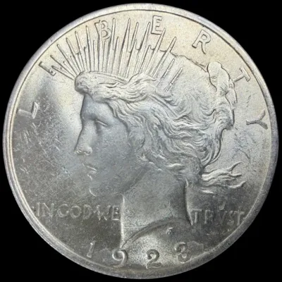 Sale Photo Thumbnail #36: Obverse side of a 1923 Peace silver dollar featuring Lady Liberty in profile.