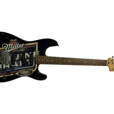 Sale Photo Thumbnail #42: Fender Squier Stratocaster electric guitar featuring a promotional Miller Genuine Draft graphic on a black body.