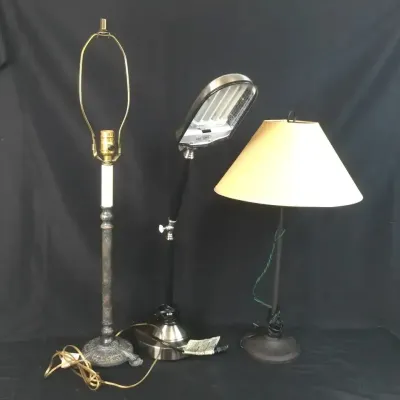 Sale Photo Thumbnail #33: Set of three assorted table lamps, including a brass harp lamp, an adjustable OttLite craft lamp, and a small dark metal lamp with a fabric shade.