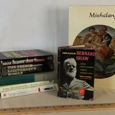 Sale Photo Thumbnail #18: Collection of various books, including an oversize Abrams Michelangelo art book, a hardcover edition of Four Plays by Bernard Shaw, and a stack of fiction hardcovers.