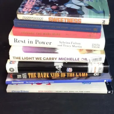 Sale Photo Thumbnail #76: Stack of assorted hardcover and paperback books, featuring sports biographies including Walter Payton's "Sweetness" and Ron Santo's "Heart and Soul of the Cubs".