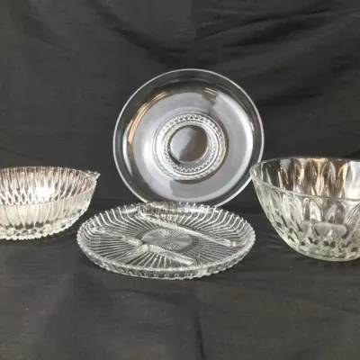 Sale Photo Thumbnail #36: Four-piece clear pressed glassware collection, including two textured serving bowls, a round dish, and a three-section divided relish tray.