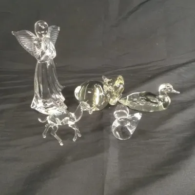 Sale Photo Thumbnail #35: Group of clear glass figurines, including a praying angel, duck, pig, deer, and small swan paperweight.
