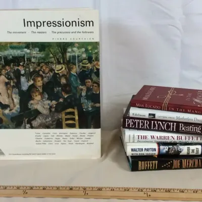Sale Photo Thumbnail #92: Collection of assorted hardcover and paperback books, featuring an oversize art history book titled Impressionism by Pierre Courthion alongside titles on finance, biography, and fiction.