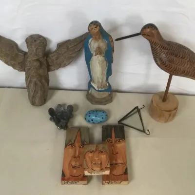 Sale Photo Thumbnail #38: Collection of folk art sculptures, including a carved wooden shorebird decoy, a carved stone angel, a painted Virgin Mary figure, and signed hand-painted wood portraits.