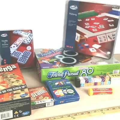 Sale Photo Thumbnail #64: Assortment of modern table and board games, including Pavilion Mahjong, Trivial Pursuit Totally 80s, Classic Jenga, and dominoes, all appearing in complete condition.
