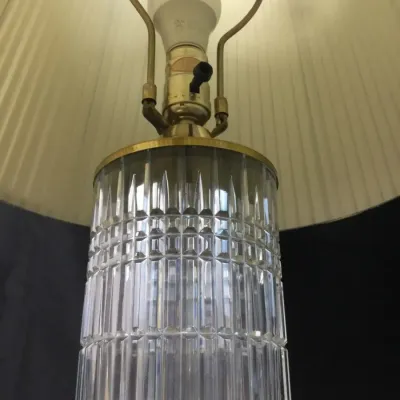 Sale Photo Thumbnail #83: Vintage cut glass table lamp featuring a cylindrical textured crystal body, brass hardware, and a pleated fabric shade.