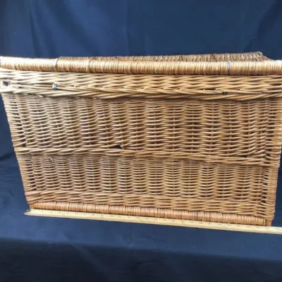 Sale Photo Thumbnail #51: Large vintage woven wicker storage hamper or trunk with a hinged lid, displayed next to a yardstick for scale.
