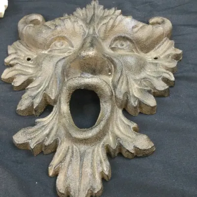 Sale Photo Thumbnail #82: Cast iron Green Man wall fountain spout or plaque with intricate leaf details and weathered finish.