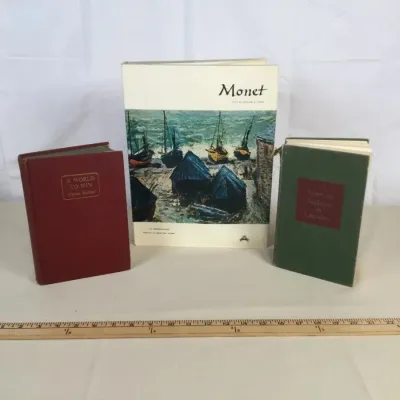 Sale Photo Thumbnail #61: Collection of three books, including an art volume titled Monet by William C. Seitz alongside two hardcovers.
