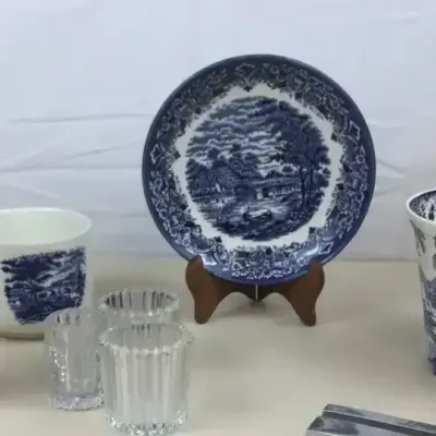 Sale Photo Thumbnail #29: Collection of decorative ceramics and glassware, including blue-and-white transferware pieces, a polychrome porcelain candlestick vase, and small ribbed glass holders.
