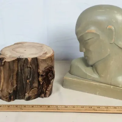 Sale Photo Thumbnail #3: Art Deco style bust displayed alongside a small natural wood log slice riser, with minor paint wear on the bust.
