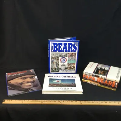 Sale Photo Thumbnail #56: Collection of Chicago sports books focusing on the Chicago Bears and Walter Payton, including hardcovers and paperbacks shown with a wooden yardstick.