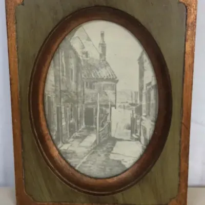 Sale Photo Thumbnail #98: Vintage framed black-and-white architectural etching set inside a distinctive oval cutout wood frame with gilt-toned trim.