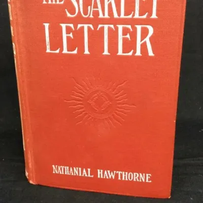 Sale Photo Thumbnail #9: Hardcover edition of "The Scarlet Letter" by Nathaniel Hawthorne, bound in orange cloth with white lettering and a central embossed emblem.