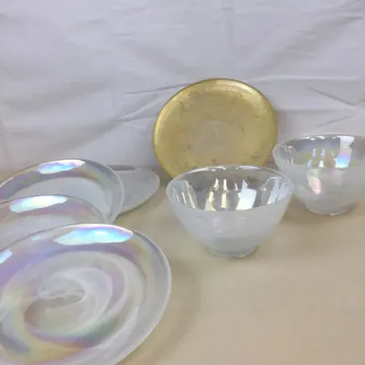 Sale Photo Thumbnail #47: Set of iridized frosted glass plates and bowls alongside a round brass display dish.