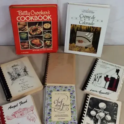 Sale Photo Thumbnail #10: Collection of vintage cookbooks, including hardcovers and spiral-bound community recipe collections such as Betty Crocker's Cookbook and Crème de Colorado Cookbook.