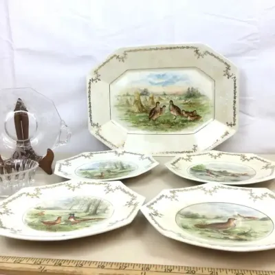 Sale Photo Thumbnail #49: Vintage game bird ceramic platter and matching plate set with floral filigree borders, displayed alongside clear pressed glass serving pieces.