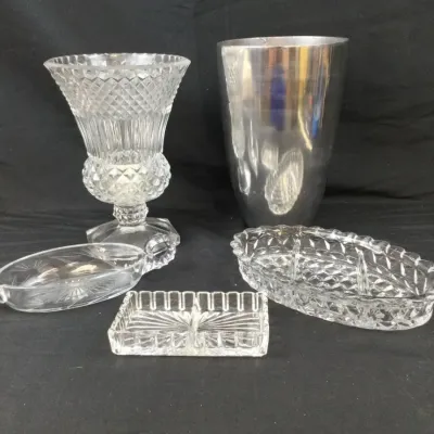 Sale Photo Thumbnail #37: Collection of glassware and metal serving pieces, including a diamond-cut glass urn vase, a metallic bucket, and three pressed glass dish trays.