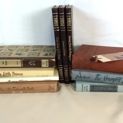 Sale Photo Thumbnail #88: Collection of vintage hardbound books, including copies of 'The Little Prince', 'Where the Sidewalk Ends', and gilt-embossed classics.