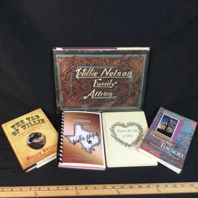 Sale Photo Thumbnail #75: Collection of five books and booklets, featuring Willie Nelson memorabilia including 'Willie Nelson Family Album' and 'The Tao of Willie'.