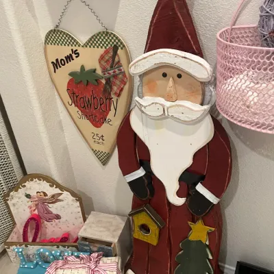 Sale Photo Thumbnail #65: Handcrafted wooden Santa Claus figure standing beside a heart-shaped strawberry shortcake wall sign and small decorative keepsakes.