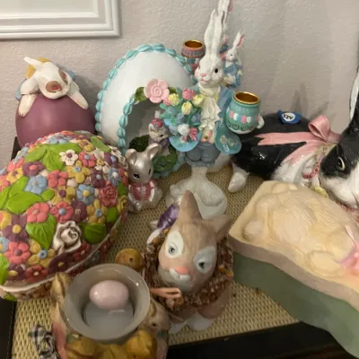 Sale Photo Thumbnail #162: Collection of spring and Easter decor, featuring rabbit figurines, floral ceramic eggs, and tealight holders.