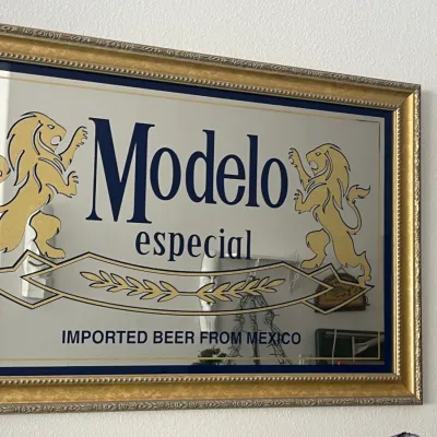 Sale Photo Thumbnail #251: Framed Modelo Especial bar mirror featuring the brand's logo and lion crests in a beaded gold-tone frame.
