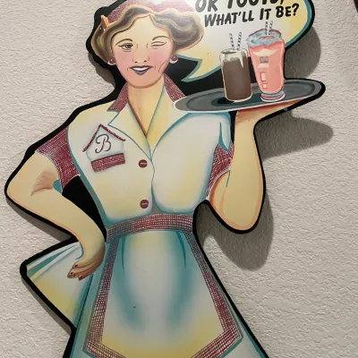 Sale Photo Thumbnail #64: Vintage-style 1950s diner waitress wooden wall sign featuring a speech bubble reading "Ok Toots, What'll It Be?".