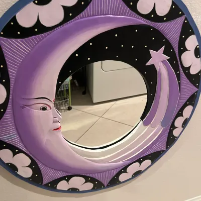 Sale Photo Thumbnail #257: Hand-painted round wall mirror with celestial and floral motifs, featuring a purple crescent moon face and shooting star.