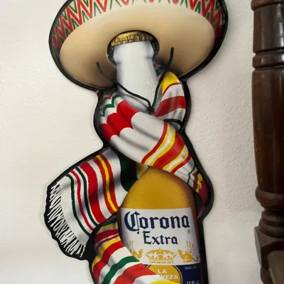 Sale Photo Thumbnail #246: Vintage Corona Extra metal die-cut bar sign featuring a beer bottle dressed in a sombrero and sarape.