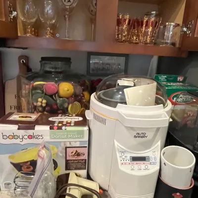 Sale Photo Thumbnail #35: Funai Auto Bakery bread machine alongside a boxed Babycakes donut maker, vintage hand mixer, and various kitchen glassware.