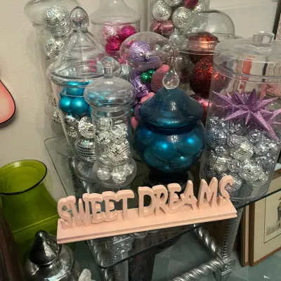 Sale Photo Thumbnail #166: Collection of glass apothecary jars filled with colorful disco ball ornaments, displayed alongside a pink 'Sweet Dreams' tabletop sign.