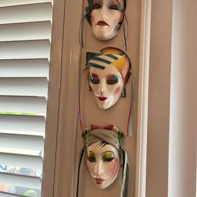 Sale Photo Thumbnail #40: Trio of 1980s Art Deco Revival ceramic theatrical masks mounted on a wall.