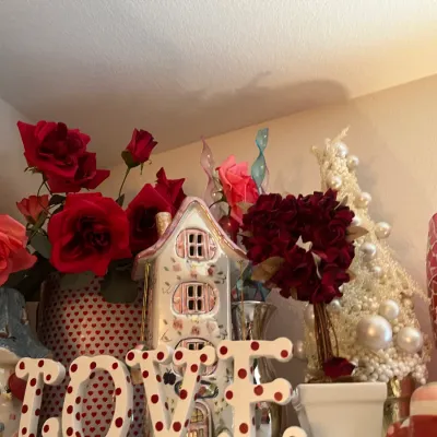 Sale Photo Thumbnail #227: Collection of Valentine's Day themed decor including faux red and pink roses, a ceramic house, a polka dot LOVE sign, and a pearl-embellished decorative cone.