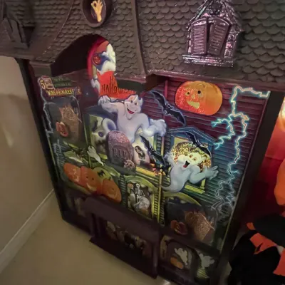 Sale Photo Thumbnail #89: Vintage Halloween haunted house display board featuring ghostly characters, jack-o'-lanterns, and a mansion-style frame.