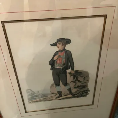 Sale Photo Thumbnail #168: Framed antique hand-colored engraving depicting a man in traditional European regional attire, professionally double-matted in a wood frame.