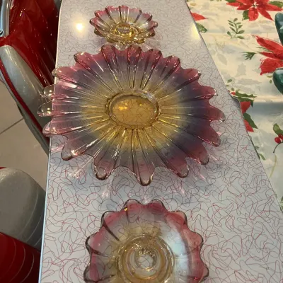 Sale Photo Thumbnail #14: Set of three vintage iridescent glass bowls with ruffled edges, featuring a yellow-to-pink gradient hue.