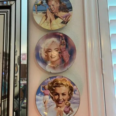 Sale Photo Thumbnail #43: Set of three vintage Marilyn Monroe collector plates with metallic gold accents, mounted on wire wall hangers.