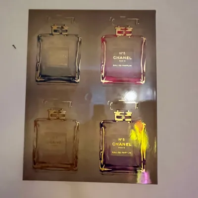 Sale Photo Thumbnail #83: Pop art wall print depicting four colorful Chanel No. 5 perfume bottles in gold foil-style frames.